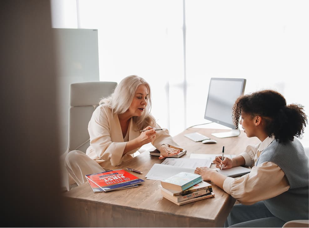 A GEM Mentor and mentee work together at a desk